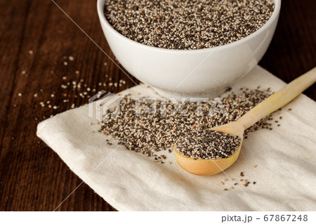 Chia seeds in a bowl with wooden spoon 67867248
