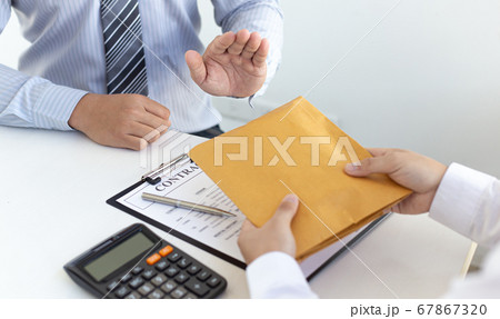 Businessmen make dollar payments while signing an investment agreement to be a partner in an illegal and successful manner, Bribery and corruption concept. Businessmen make dollar payments while signing an investment agreement to be a partner in an illegal and successful manner, Bribery and corruption concept. 67867320
