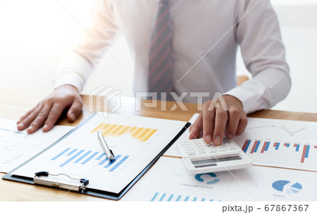 Businessmen use calculators to calculate the cost of real estate investments to prepare for offering to customers who want to share shares with the company, Business Financing Accounting Banking Conce Businessmen use calculators to calculate the cost of real estate investments to prepare for offering to customers who want to share shares with the company, Business Financing Accounting Banking Conce 67867367