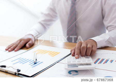 Businessmen use calculators to calculate the cost of real estate investments to prepare for offering to customers who want to share shares with the company, Business Financing Accounting Banking Conce Businessmen use calculators to calculate the cost of real estate investments to prepare for offering to customers who want to share shares with the company, Business Financing Accounting Banking Conce 67867368