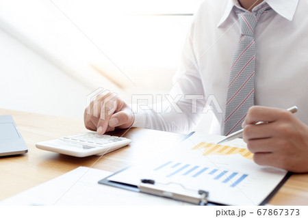 Businessmen use calculators to calculate the cost of real estate investments to prepare for offering to customers who want to share shares with the company, Business Financing Accounting Banking Conce Businessmen use calculators to calculate the cost of real estate investments to prepare for offering to customers who want to share shares with the company, Business Financing Accounting Banking Conce 67867373