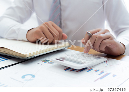 Businessmen use calculators to calculate the cost of real estate investments to prepare for offering to customers who want to share shares with the company, Business Financing Accounting Banking Conce Businessmen use calculators to calculate the cost of real estate investments to prepare for offering to customers who want to share shares with the company, Business Financing Accounting Banking Conce 67867416