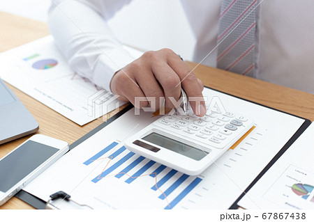 Businessmen use calculators to calculate the cost of real estate investments to prepare for offering to customers who want to share shares with the company, Business Financing Accounting Banking Conce Businessmen use calculators to calculate the cost of real estate investments to prepare for offering to customers who want to share shares with the company, Business Financing Accounting Banking Conce 67867438