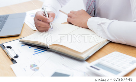 Businessmen use calculators to calculate the cost of real estate investments to prepare for offering to customers who want to share shares with the company, Business Financing Accounting Banking Conce Businessmen use calculators to calculate the cost of real estate investments to prepare for offering to customers who want to share shares with the company, Business Financing Accounting Banking Conce 67867449