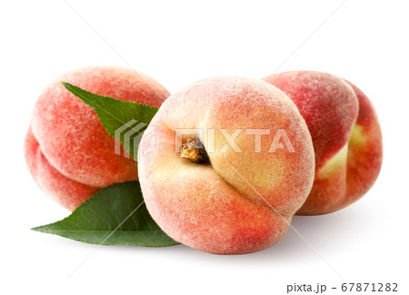 Ripe peaches with green leaves on a white 67871282