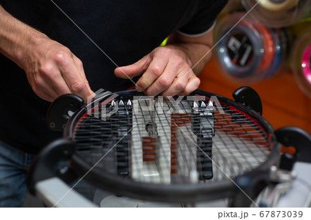 Process of stringing a tennis racket in a tennis shop, sport and leisure concept 67873039