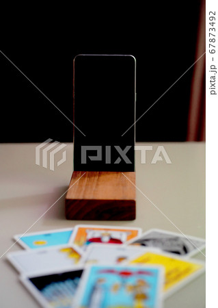 Defocused mystic ritual with tarot cards, and candles.  67873492
