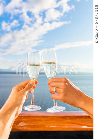Luxury honeymoon cruise couple toasting champagne. Travel holiday newlyweds drinking with wedding rings holding glasses doing cheers at sunset view of cruise holiday destination Luxury honeymoon cruise couple toasting champagne. Travel holiday newlyweds drinking with wedding rings holding glasses doing cheers at sunset view of cruise holiday destination 67875118