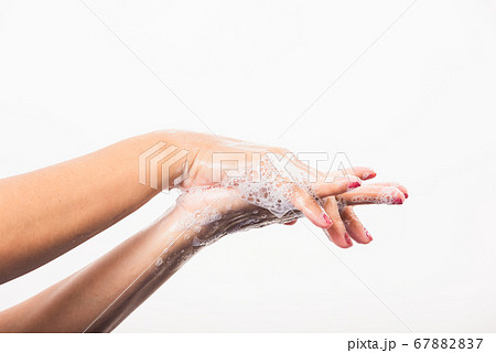 Woman washing hands by soap for cleanliness 67882837
