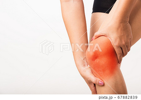 Woman holding her painful knee 67882839