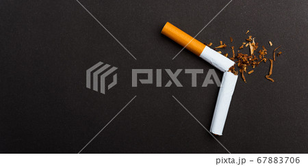 broken pile cigarette or tobacco on black 67883706