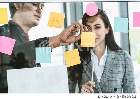 Business people work on project planning board 67885812