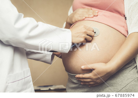 Pregnant Woman and Gynecologist Doctor at Hospital 67885974