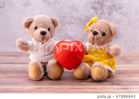 couple teddy bear with heart on table wooden. 67886843