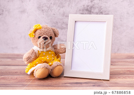 teddy bear with Picture frame on table wooden. 67886858