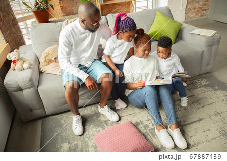 Young african family during quarantine, insulation spending time together at home 67887439