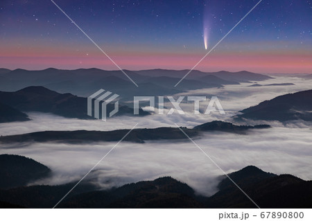 Comet Neowise C/2020 F3 at sunet over misty mountains. 67890800