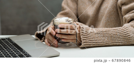 Female take a break with a cup of beverage while 67890846
