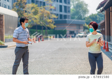 Asian middle aged people wearing mask and keep Asian middle aged people wearing mask and keep 67891580