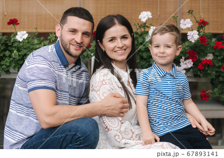Portrait of family outdoors. Happy little boy with mom and dad 67893141