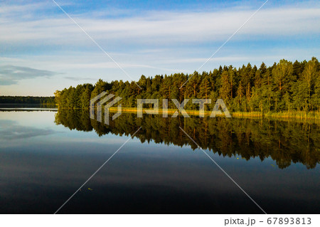 Top view of Bolta lake in the forest in the Braslav lakes National Park at dawn, the most beautiful places in Belarus.An island in the lake.Belarus. 67893813