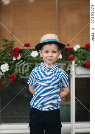 Portrait of little boy outdoor in summer time. Happy smiled kid. in straw hat 67895978