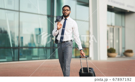 Serious Businessman Making Business Trip Walking At Airport Outdoors, Panorama 67897192