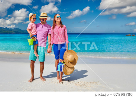 Family with three year old boy on beach. 67898780