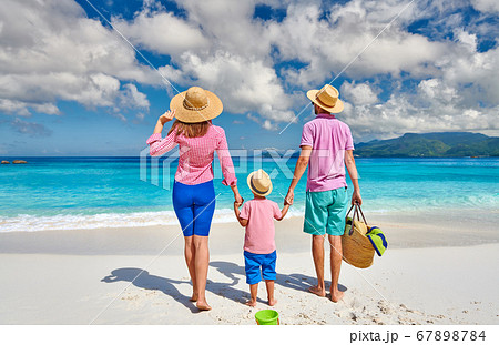 Family with three year old boy on beach. 67898784