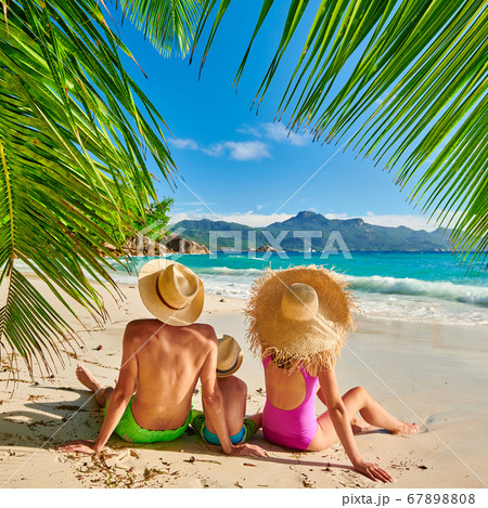Family with three year old boy on beach. 67898808