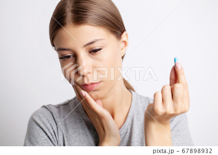Portrait of a pretty young woman having a severe toothache Portrait of a pretty young woman having a severe toothache 67898932