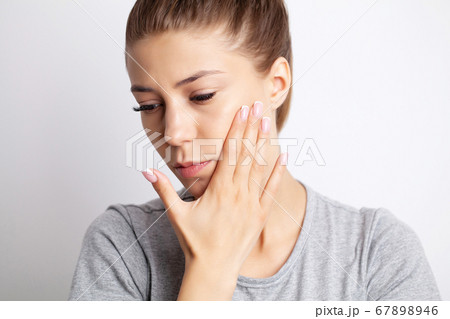 Portrait of a pretty young woman having a severe toothache 67898946