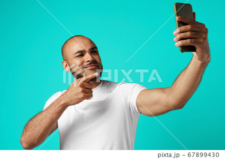 Young cheerful african american man taking selfie picture Young cheerful african american man taking selfie picture 67899430