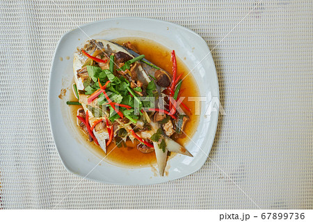 Steamed Butterf fish (SILVER POMFRET)with soy sauce in white dish, top view 67899736