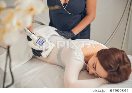 Lying female enjoying time during skincare procedure 67900342