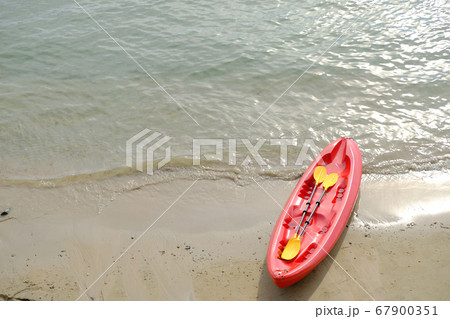 red boat on the beach, kayak on the sand and beach background red boat on the beach, kayak on the sand and beach background 67900351