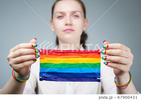 Photo of woman holding rainbow protective mask 67900431