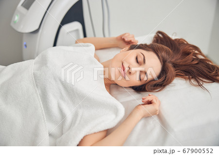 Attractive woman with dark hair having medical treatment 67900552