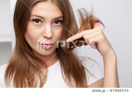 Woman doing hair care procedures in the bathroom Woman doing hair care procedures in the bathroom 67900554
