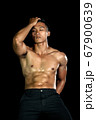 Muscle bodybuilder asia men posing muscle front on the black background. Body gym big chest and 67900639