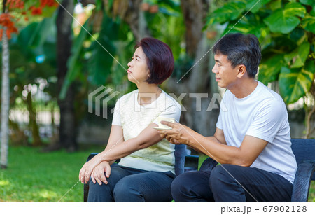 Asian middle aged male asking to make up with his Asian middle aged male asking to make up with his 67902128