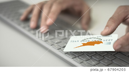 Man pays online with credit card with printed flag of Cyprus. Fictional numbers Man pays online with credit card with printed flag of Cyprus. Fictional numbers 67904203
