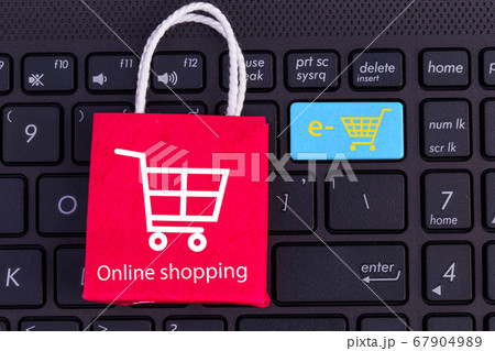 Red paper shopping bag on laptop keyboard. Ideas about online shopping. e-commerce or electronic commerce is a transaction of buying or services online over the internet just search and clicks. Red paper shopping bag on laptop keyboard. Ideas about online shopping. e-commerce or electronic commerce is a transaction of buying or services online over the internet just search and clicks. 67904989