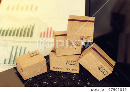 Grouping of cardboard boxes packing financial investment products on on notebook keyboard. Idea of marketing planning and shipping costs, Control financial budget and service charge. Grouping of cardboard boxes packing financial investment products on on notebook keyboard. Idea of marketing planning and shipping costs, Control financial budget and service charge. 67905016