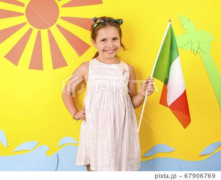 Little girl on a bright background with Italian flag. The concept of summer, beach holidays and Little girl on a bright background with Italian flag. The concept of summer, beach holidays and 67906769