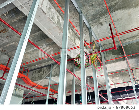 KUALA LUMPUR, MALAYSIA -APRIL 12, 2018: Drywall installation work in progress by construction workers at the construction site. It is the easiest and cheapest way to do partition for the interior wall KUALA LUMPUR, MALAYSIA -APRIL 12, 2018: Drywall installation work in progress by construction workers at the construction site. It is the easiest and cheapest way to do partition for the interior wall 67909053