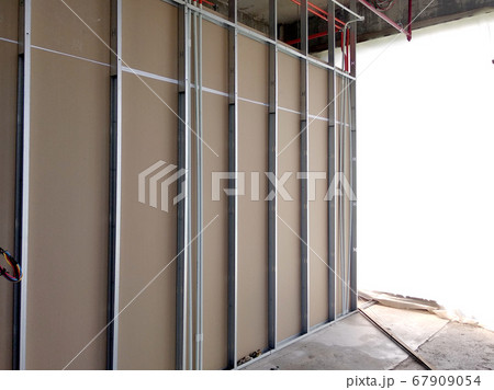 KUALA LUMPUR, MALAYSIA -APRIL 12, 2018: Drywall installation work in progress by construction workers at the construction site. It is the easiest and cheapest way to do partition for the interior wall 67909054