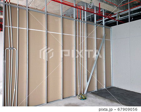 KUALA LUMPUR, MALAYSIA -APRIL 12, 2018: Drywall installation work in progress by construction workers at the construction site. It is the easiest and cheapest way to do partition for the interior wall 67909056