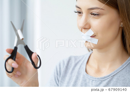 Stop smoking, woman cuts a cigarette with scissors 67909140