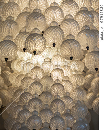 Glowing light bulb hanging from the ceiling hall background.  67915380